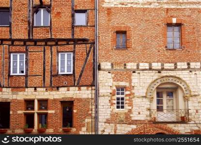 Facades of brick medieval houses in town of Albi in south France
