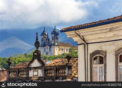 Facades of historic houses and churches with the mountains of the city of Ouro Preto in Minas Gerais. Facades of historic houses and churches