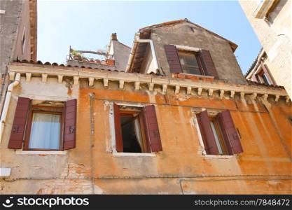 Facades of houses on a street in Venice, Italy