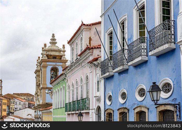 Facades of old colorful colonial style houses and churches in the historic district of Pelourinho in the city of Salvador in Bahia, Brazil. Old and colorful colonial style facades in the district of Pelourinho in Salvador, Bahia