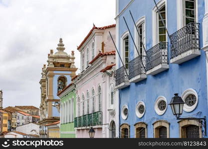 Facades of old colorful colonial style houses and churches in the historic district of Pelourinho in the city of Salvador in Bahia, Brazil. Old and colorful colonial style facades in the district of Pelourinho in Salvador, Bahia