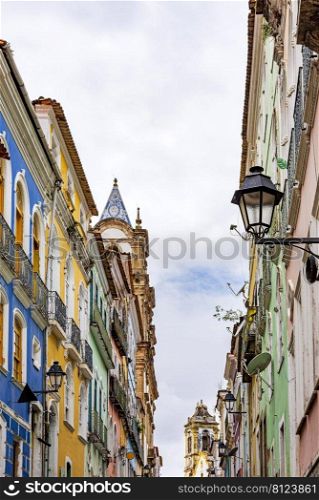 Facades of old houses and church towers in colonial style in the streets of the Pelourinho neighborhood in the city of Salvador, Bahia. Facades of old houses and church towers in colonial style