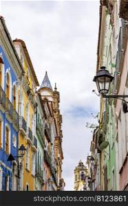 Facades of old houses and church towers in colonial style in the streets of the Pelourinho neighborhood in the city of Salvador, Bahia. Facades of old houses and church towers in colonial style