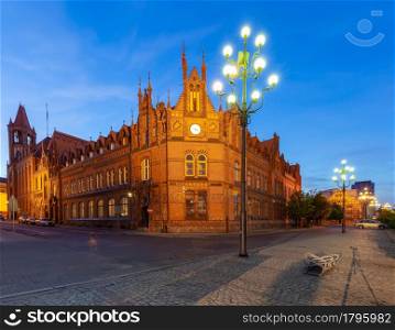 Facades of old houses on the central city embankment at dawn. Bydgoszcz. Poland.. Bydgoszcz. Ancient houses on the embankment in the early morning.