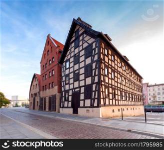 Facades of old houses on the central city embankment at dawn. Bydgoszcz. Poland.. Bydgoszcz. Ancient houses on the embankment in the early morning.