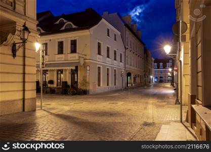 Facades of old houses on the central city street at dawn. Bydgoszcz. Poland.. Bydgoszcz. Old houses on in the night illumination.
