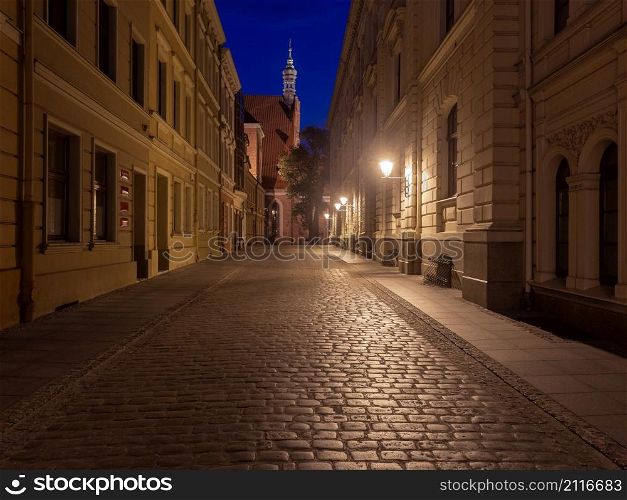 Facades of old houses on the central city street at dawn. Bydgoszcz. Poland.. Bydgoszcz. Old houses on in the night illumination.