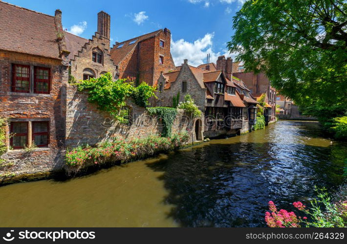 Facades of old medieval buildings on the canals of Bruges.. Brugge. Medieval houses over the canal.