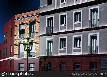 Facades of the Houses in the Spanish City of Cadis at Night, Retro Image Filtered Style