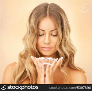 face and hands of beautiful woman with diamond