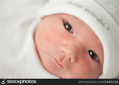 face baby in a white hat on a white background. face baby in a white hat