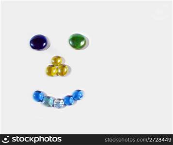 Face made of colored beads on a white background