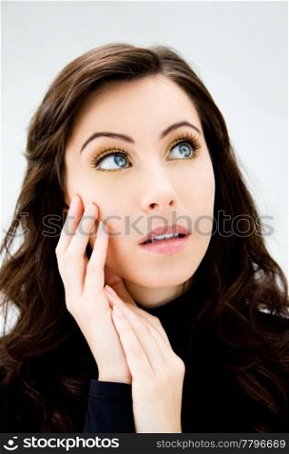 Face of a beautiful blue eyed brunette, isolated