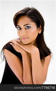 Face of a beautiful Hindi woman with subtle blue eye makeup and strong eyes, isolated