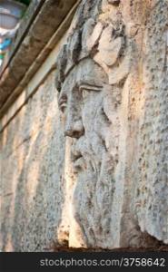 face of a man with a beard carved in stone