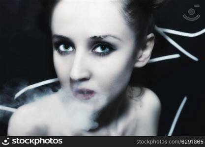 face of a young beautiful woman in the smoke