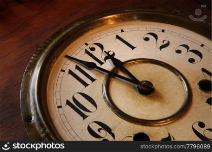Face of an antique clock; indicating nearly midnight