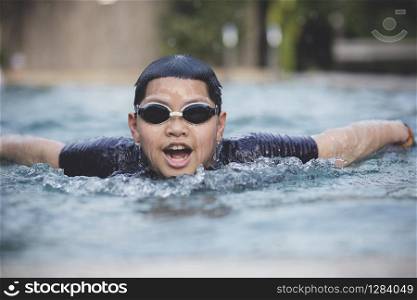 face of asian boy swimming in water sport pool