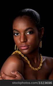 Face of beautiful African American woman with gold earrings and necklace, isolated.