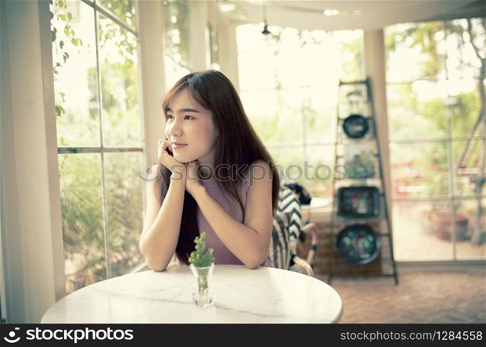 face of beautiful asian younger woman smiling with happiness in living room