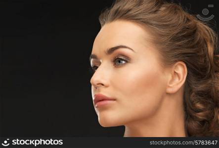 face of beautiful beautiful woman over black background