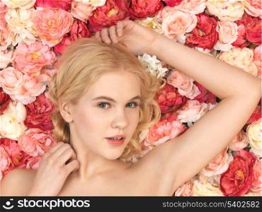 face of beautiful woman and background full of roses