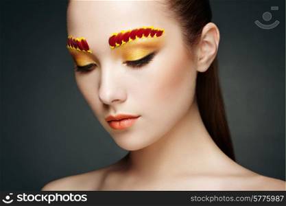 Face of beautiful woman decorated with flowers. Perfect makeup. Beauty fashion. Eyelashes. Cosmetic Eyeshadow