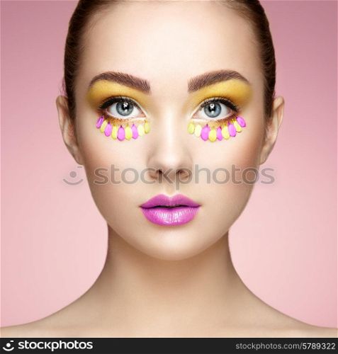 Face of beautiful woman decorated with flowers. Perfect makeup. Beauty fashion. Eyelashes. Cosmetic Eyeshadow