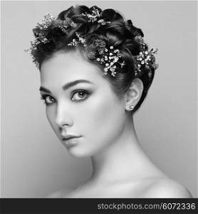 Face of beautiful woman decorated with flowers. Perfect makeup. Beauty fashion. Eyelashes. Cosmetic Eyeshadow. Black and white