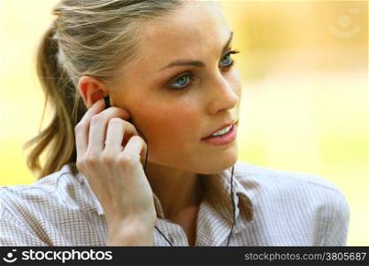 face of beautiful woman listening to music