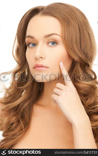 face of beautiful woman pointing at her cheek