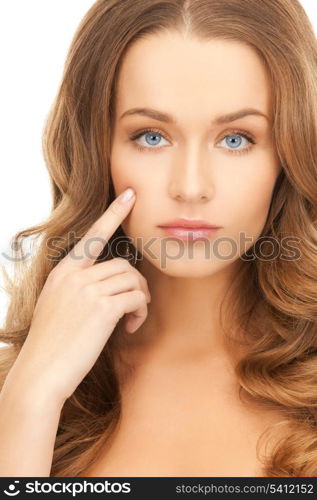 face of beautiful woman pointing at her cheek