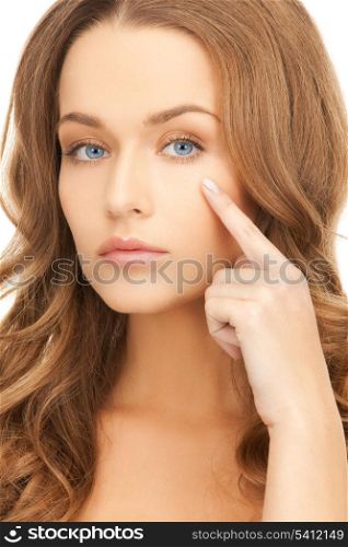 face of beautiful woman pointing at her eye area