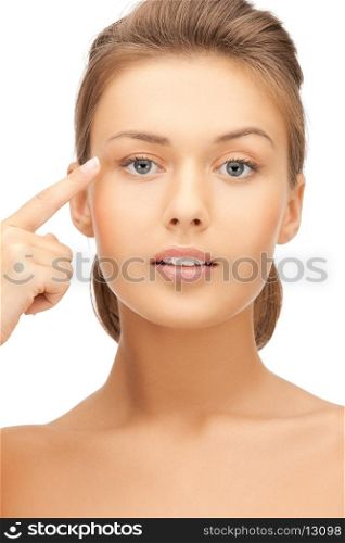 face of beautiful woman pointing at her eyebrow
