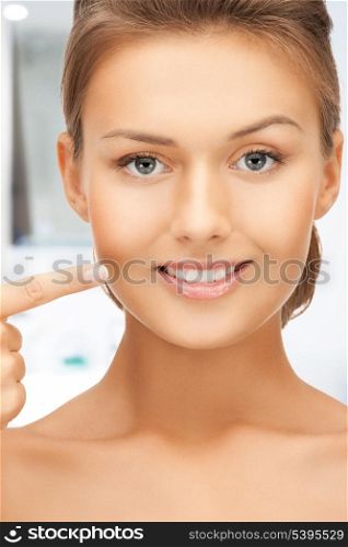 face of beautiful woman showing her teeth