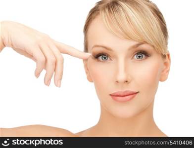 face of beautiful woman touching her eye area