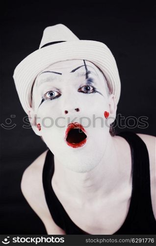Face of Funny screaming mime in white hat close up