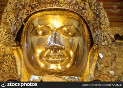 Face of golden Mahamuni Buddha statue in Mandalay, Myanmar