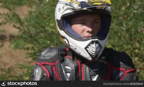 Face of young enduro racer in motorcycle protective gear closeup