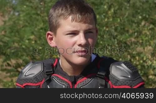 Face of young racer in motorcycle protective gear closeup