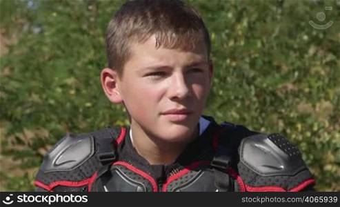 Face of young racer in motorcycle protective gear closeup