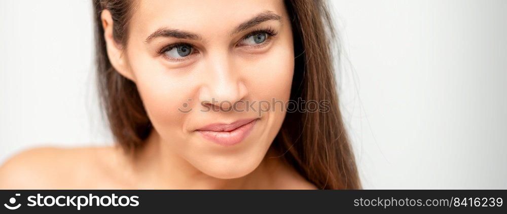 Face portrait of young caucasian woman with naked shoulders and natural make up on white background. Face portrait of young caucasian woman