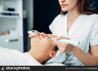 Face rejuvenation procedure to woman, beauty medicine, cosmetology clinic. Facial skincare in spa salon. Face rejuvenation procedure, beauty medicine