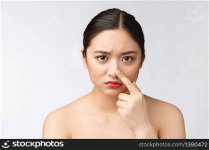 Face Skin Problem - young woman unhappy touch her skin isolated, concept for skin care, asian. Face Skin Problem - young woman unhappy touch her skin isolated, concept for skin care, asian.