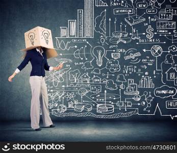 Faceless businesswoman. Businesswoman using mobile phone wearing carton box on head