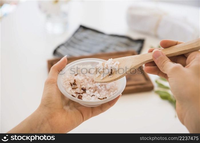 faceless female with spoon pink salt bowl