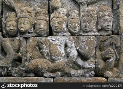 Faces on the wall of Borobudur, Java, Indonesia