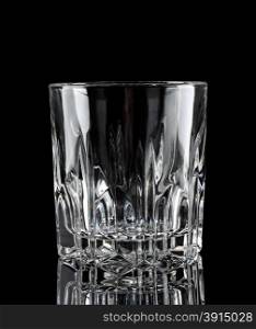 Faceted clear empty glass on a black background