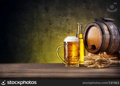 Faceted glass of beer, bottle and barrel on yellow background. Faceted glass of beer, bottle and barrel