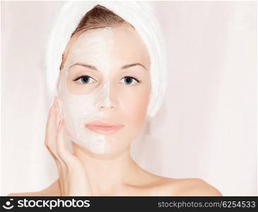 Facial mask on beautiful face, closeup portrait on female with perfect skin, woman taking care, spa health and beauty treatment